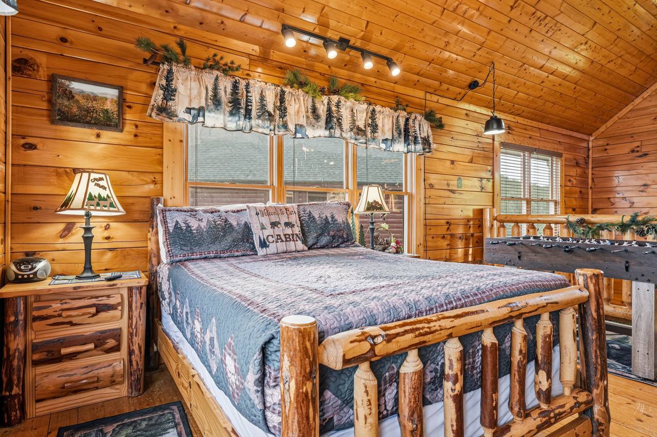 <span class="name">Loft bedroom with handcrafted queen log bed</span> <span class="name">Loft bedroom with handcrafted queen log bed</span>