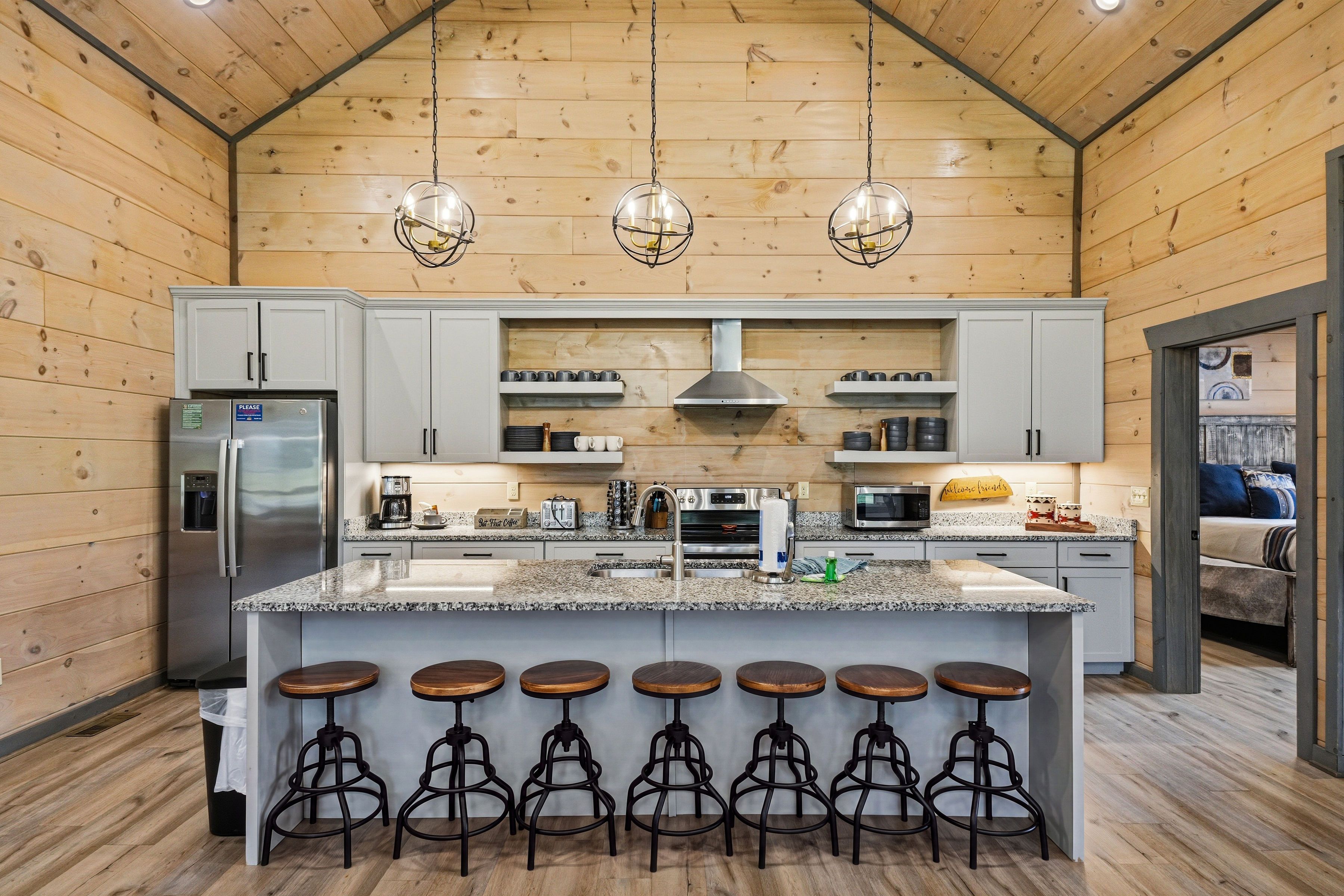 <span class="name">Kitchen island features bar seating for six guests</span>