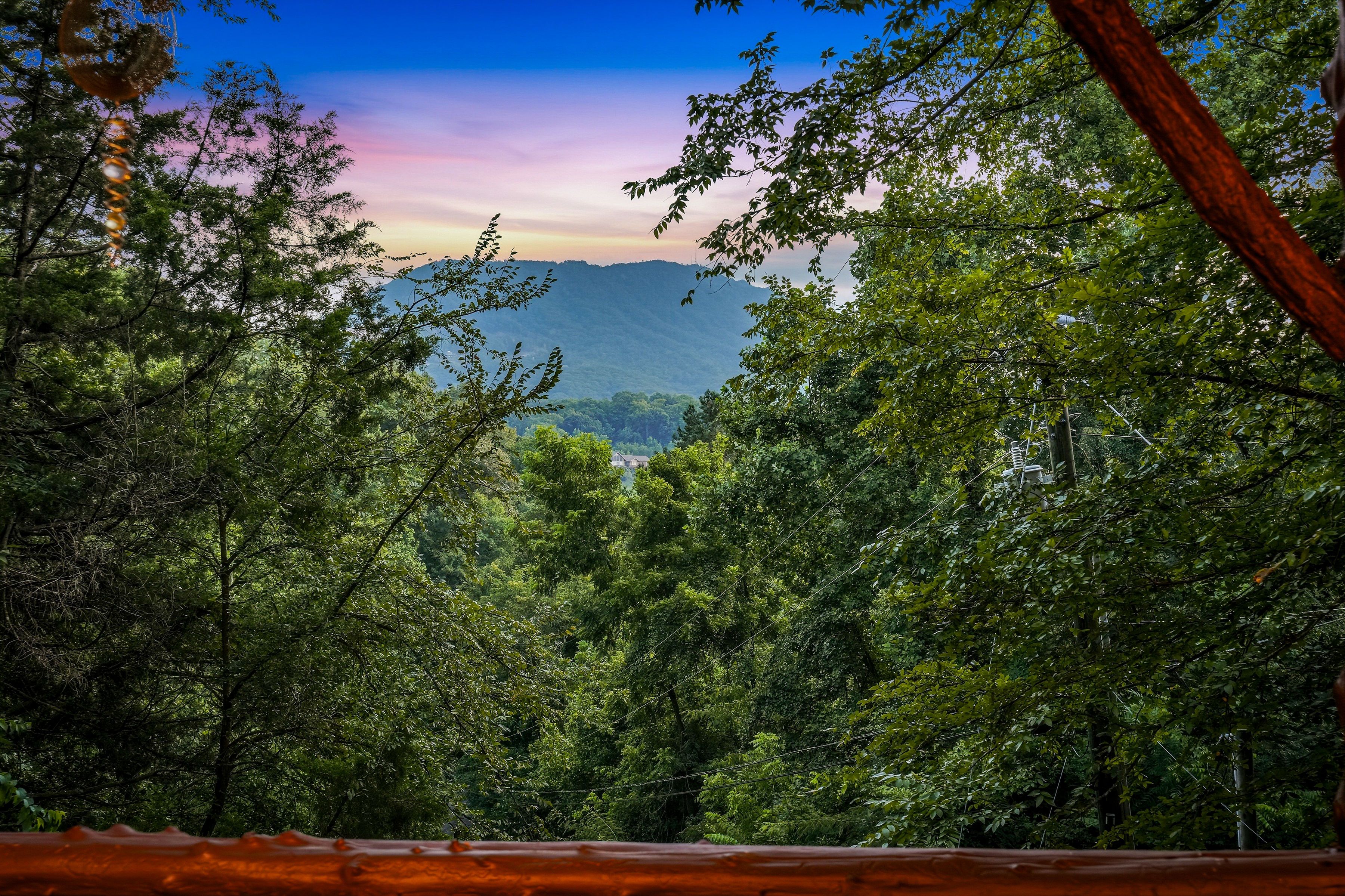 <span class="name">Smoky Mountain views peek through the trees from the deck</span>