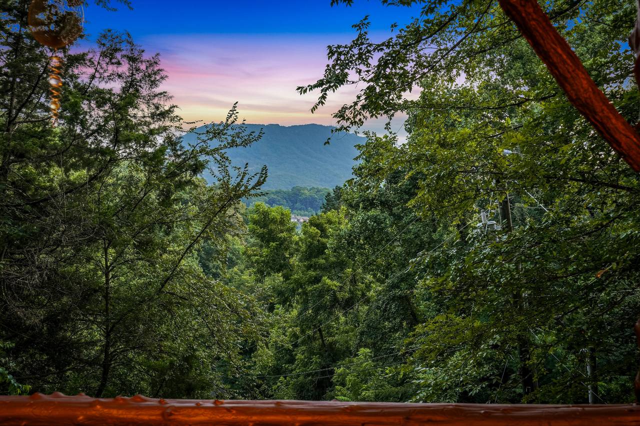 <span class="name">Smoky Mountain views peek through the trees from the deck</span> <span class="name">Smoky Mountain views peek through the trees from the deck</span>