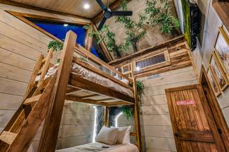 <span class="name">Upper-level twin bunk room with TV and custom treehouse</span> <span class="name">Upper-level twin bunk room with TV and custom treehouse</span>