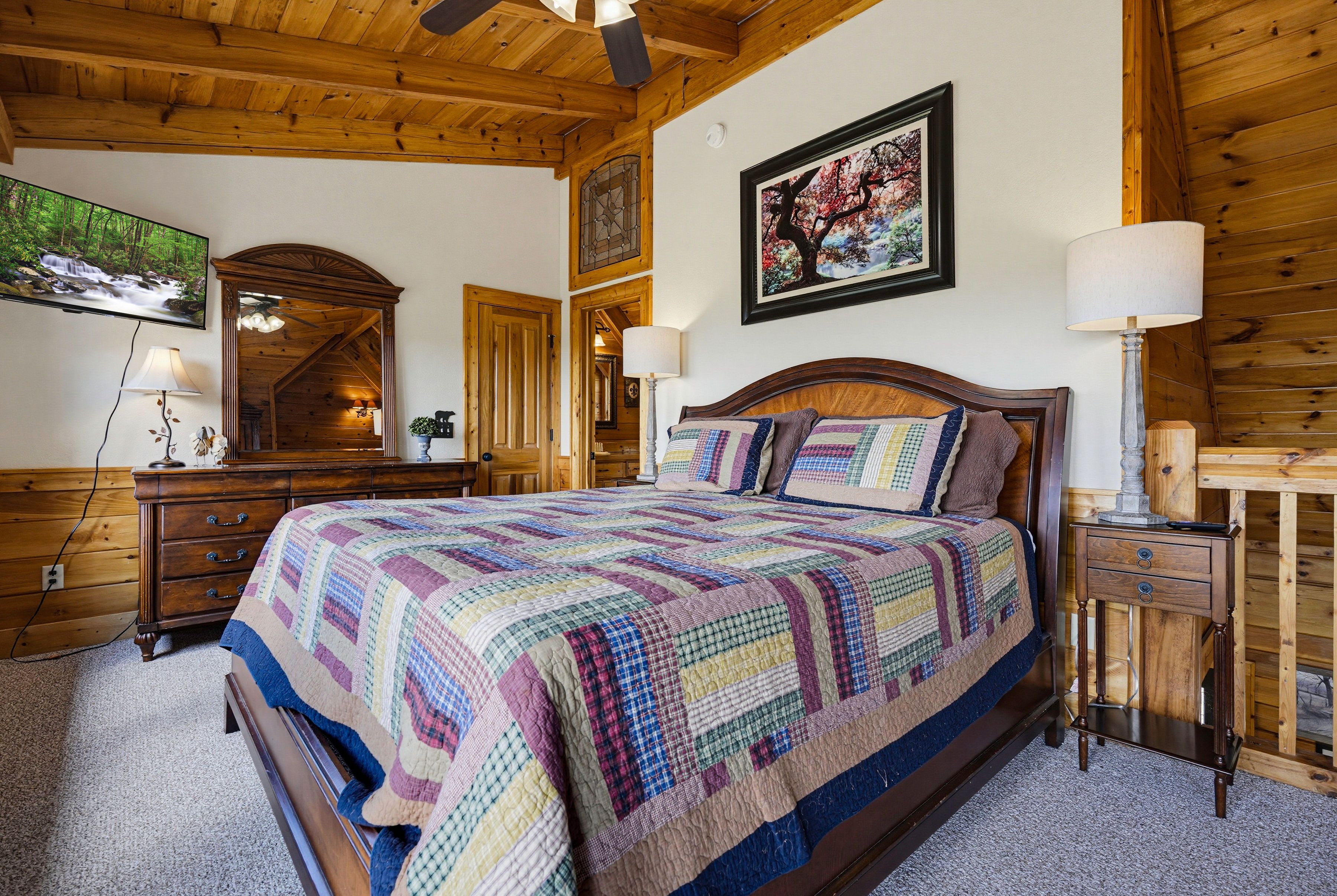 <span class="name">Upper-level loft primary suite with a comfortable king bed</span>