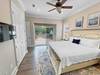 First floor master bedroom with flat screen T.V. and courtyard a