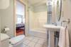 The upstairs bath features a tub and shower combo