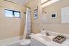The hallway bath has a tub and shower combination