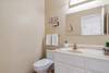 The half bath is across from the laundry area