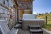 The hot tub is steps away from Bedroom 2.