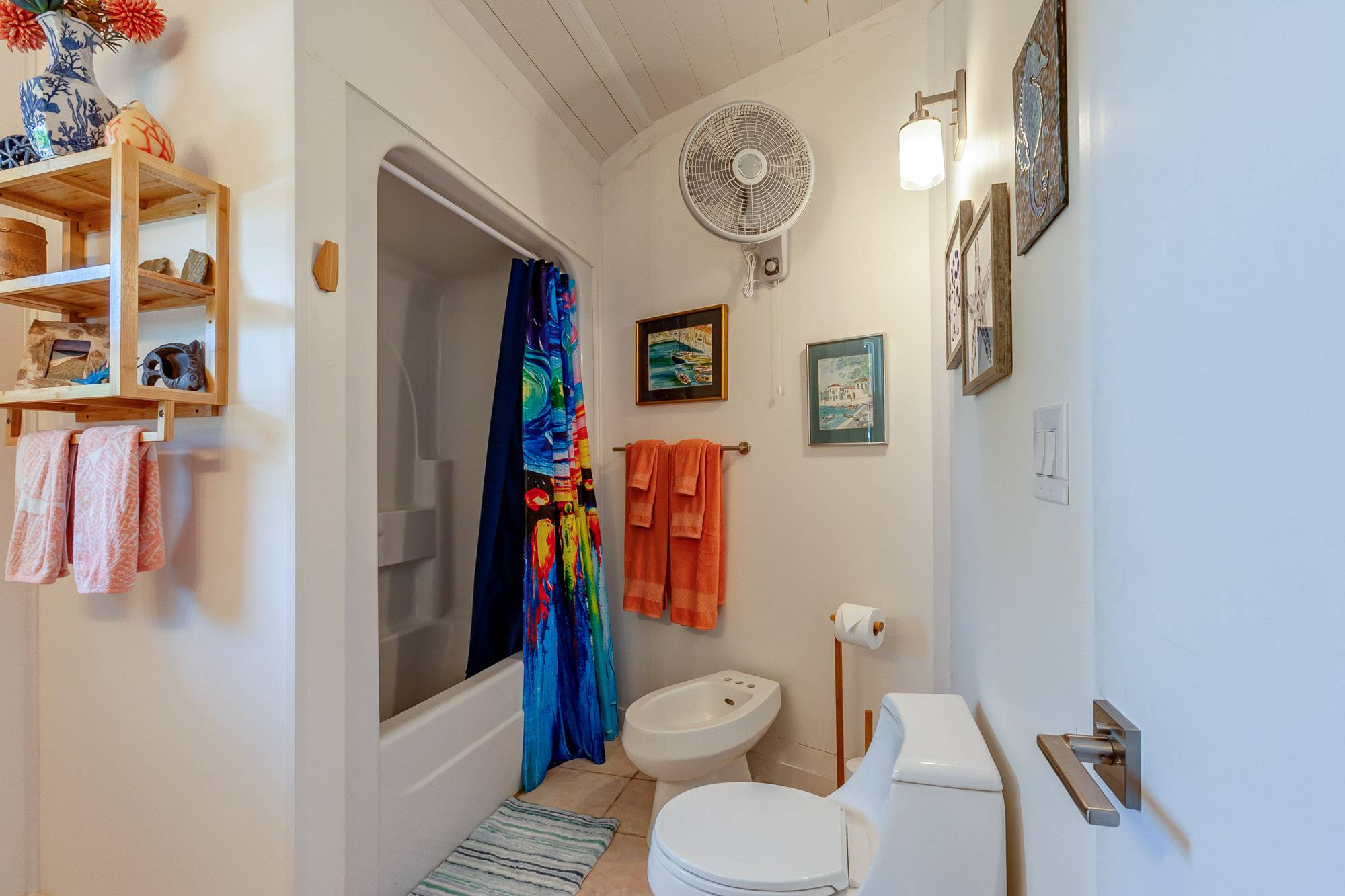 Notice the enclosed bathtub/shower with European style bidet and modern toilet design.