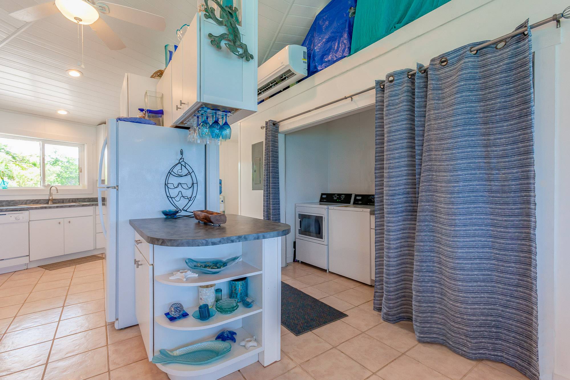 Handy laundry area with additional storage and a second refrigerator.