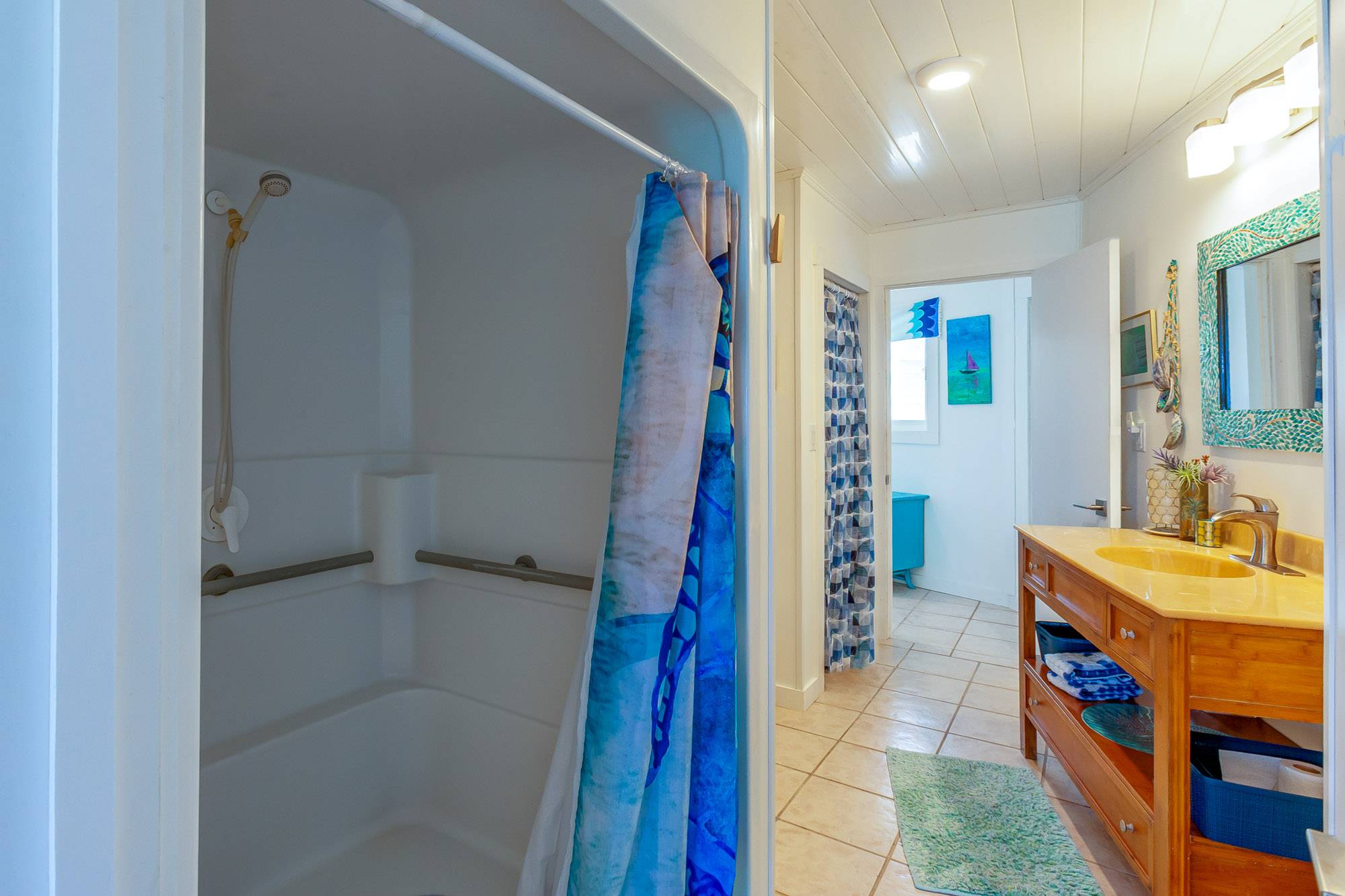 Large walk in shower with attractive bamboo vanity.