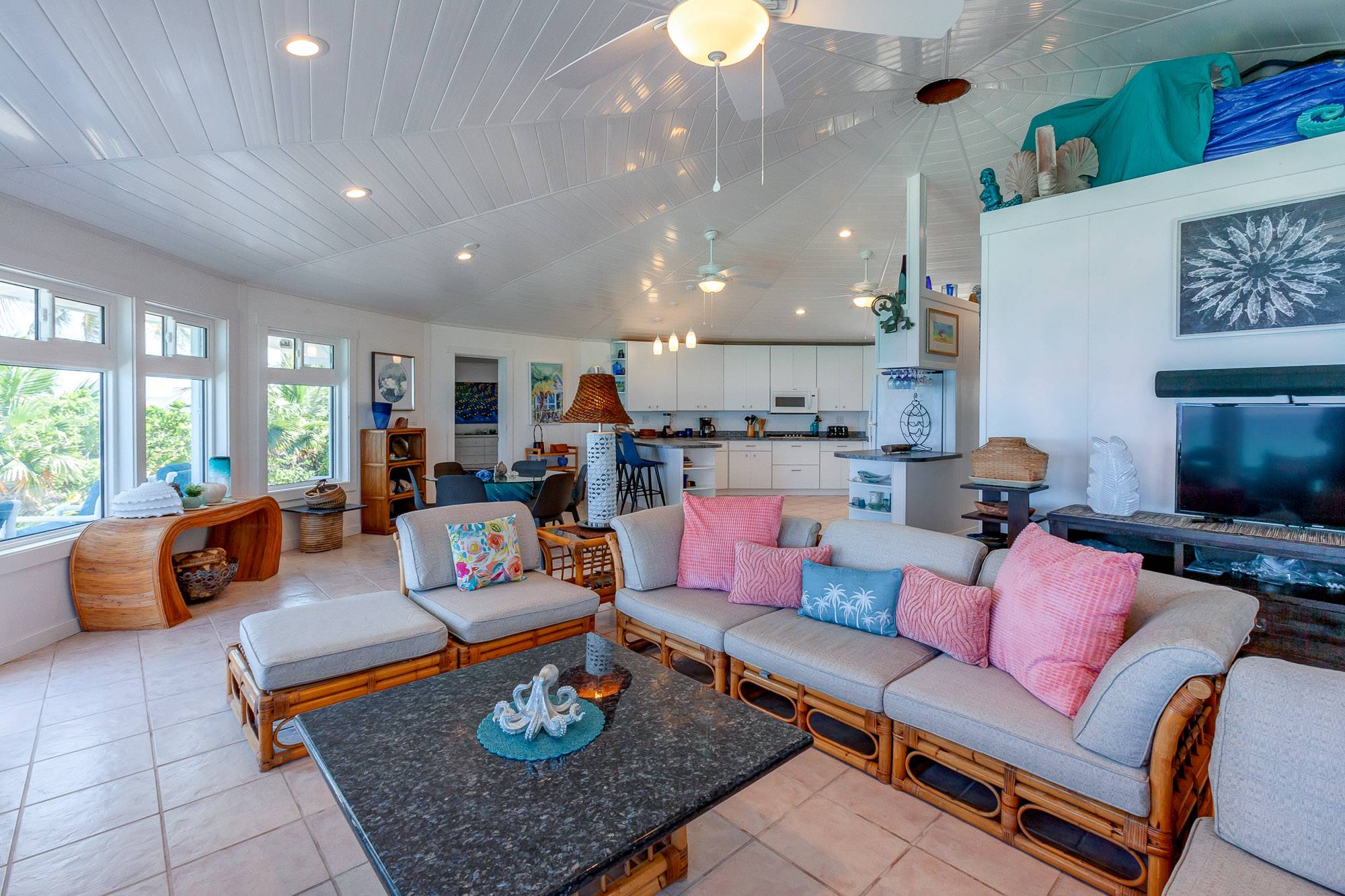 A tropical feel with open living, dining and kitchen areas while relaxing, eating or preparing food.