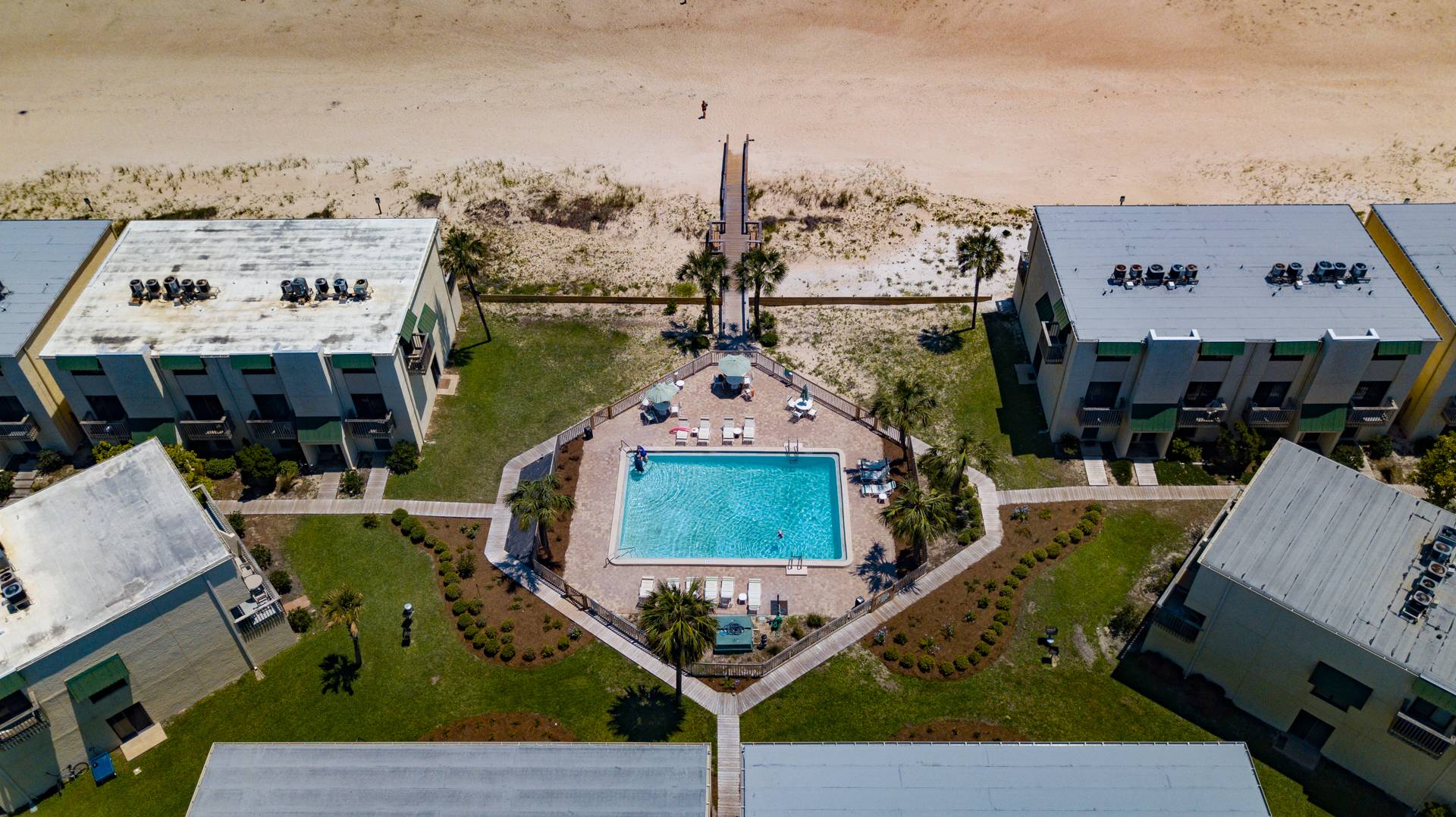 Bird's eye view of the community pool and beach boardwalk
