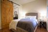 Downstairs bedroom with queen bed and full bath.