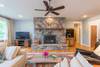 Living area with flat screen TV and wood burning fireplace.