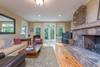 Downstairs den with large TV and doors leading to outdoor terrac