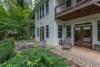 Lower level patio with outdoor seating, fire pit and corn hole b
