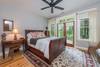 Bedroom with queen bed and doors to outdoor terrace.