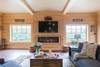 Den includes a 60" flat screen TV and electric fireplace.