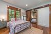 Downstairs bedroom with queen and alcove with sliding barn doors