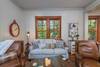 Living area with 2 reclining chairs and sofa.