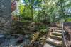 Stone steps leading down to lower level patio and fire pit area.