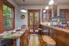 Living area opens up into dining area and kitchen, with doors to