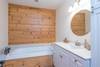 Main floor hall bathroom with jetted tub and hand held shower