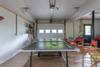 Lower level garage with ping pong and other games.