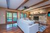 Level 2 living room w/ doors leading to porch overlooking creek.