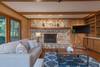 Level 2 living room w/ TV, sleeper sofa, and gas logs.
