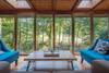 Sun room on main level, overlooking creek below.