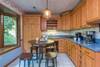 Breakfast nook off of kitchen w/ Keurig & standard coffee maker.