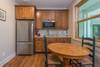 Apartment kitchenette & dining area w/ seating for 2.
