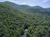 Aerial of One Acre Wood and surrounding mountains.