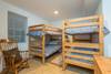 Bedroom on lower level w/ 2 sets of bunk beds.