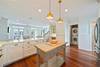 OPEN KITCHEN WITH ISLAND AND HIDDEN LAUNDRY AREA OPEN KITCHEN WITH ISLAND AND HIDDEN LAUNDRY AREA