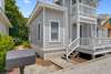FRONT EXTERIOR OF COTTAGE VIEW WITH CHARCOAL OUTDOOR GRILL