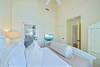 FOURTH BEDROOM WITH FLATSCREEN TV AND ACCESS TO PORCH FOURTH BEDROOM WITH FLATSCREEN TV AND ACCESS TO PORCH
