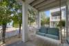 OPEN PORCH WITH HANGING, CUSHIONED SWING