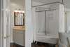 TUB SHOWER COMBO NEXT TO SINGLE VANITY AND PRIVATE BATH