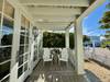 PORCH WITH LOUNGE SEATING OVERLOOKING WEST RUSKIN PORCH WITH LOUNGE SEATING OVERLOOKING WEST RUSKIN