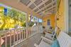 ALTERNATE VIEW OF OPEN FURNISHED FRONT PORCH WITH 3 CHAIRS AND A ALTERNATE VIEW OF OPEN FURNISHED FRONT PORCH WITH 3 CHAIRS AND A