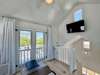 TOWER ROOM WITH HIGH CEILINGS AND MOUNTED FLATSCREEN