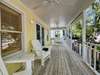 OPEN AIR FURNISHED FRONT PORCH W/ ADIRONDACK SEATING AND BENCH