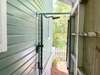ENCLOSED PRIVATE OUTDOOR SHOWER AT REAR OF HOME