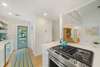 KITCHEN W/BUILT IN SHELVING AND SIDE PORCH ACCESS