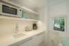 KITCHENETTE AREA WITH MICROWAVE, SINK, ETC.