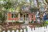 REAR VIEW OF HOME AND ENCLOSED PORCH, YARD AREA
