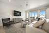 LIVING WITH WALL MOUNTED FLATSCREEN AND SEATING FOR ALL