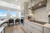 KITCHEN WITH INDUCTION STOVETOP NEXT TO DINING